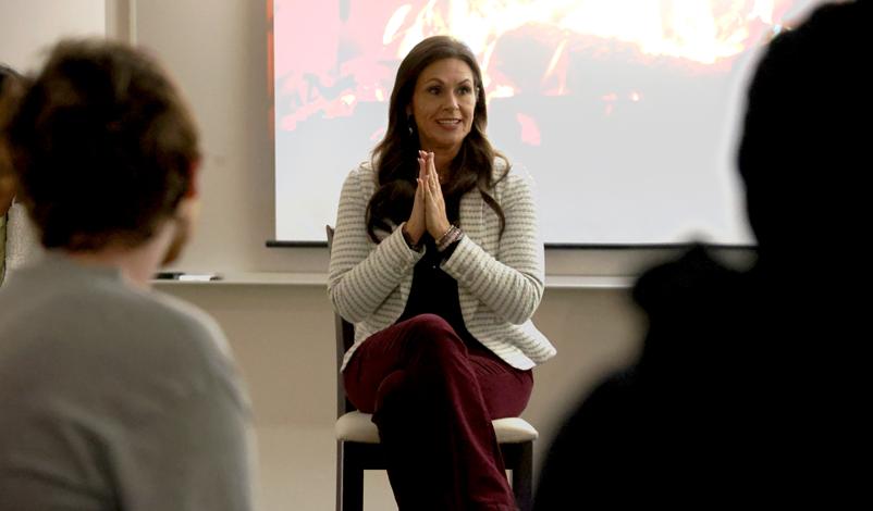 Stephanie Munsterman speaking to a croud in a group panel at mount mercy university grad center